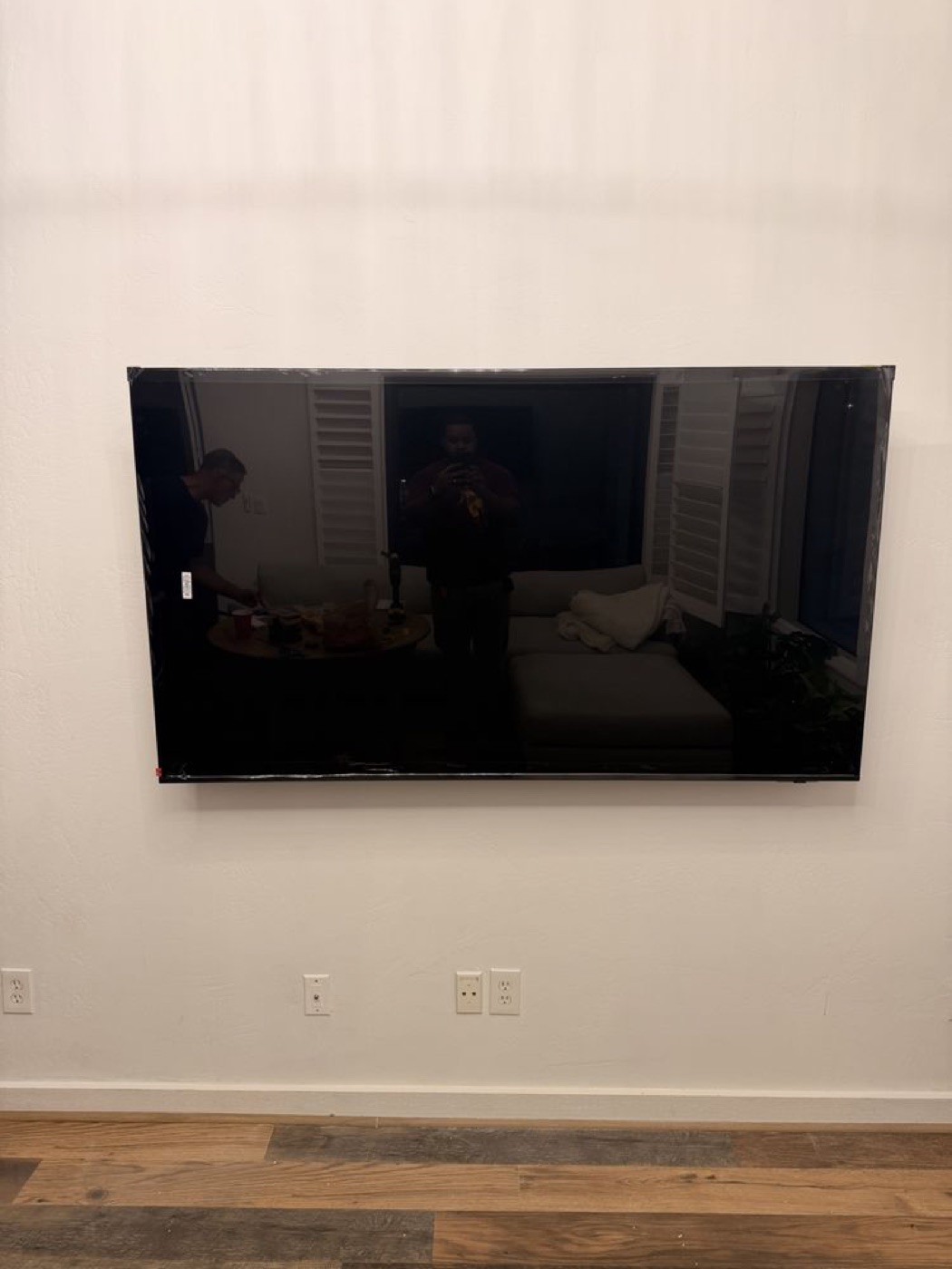 A large TV mounted on a living room wall